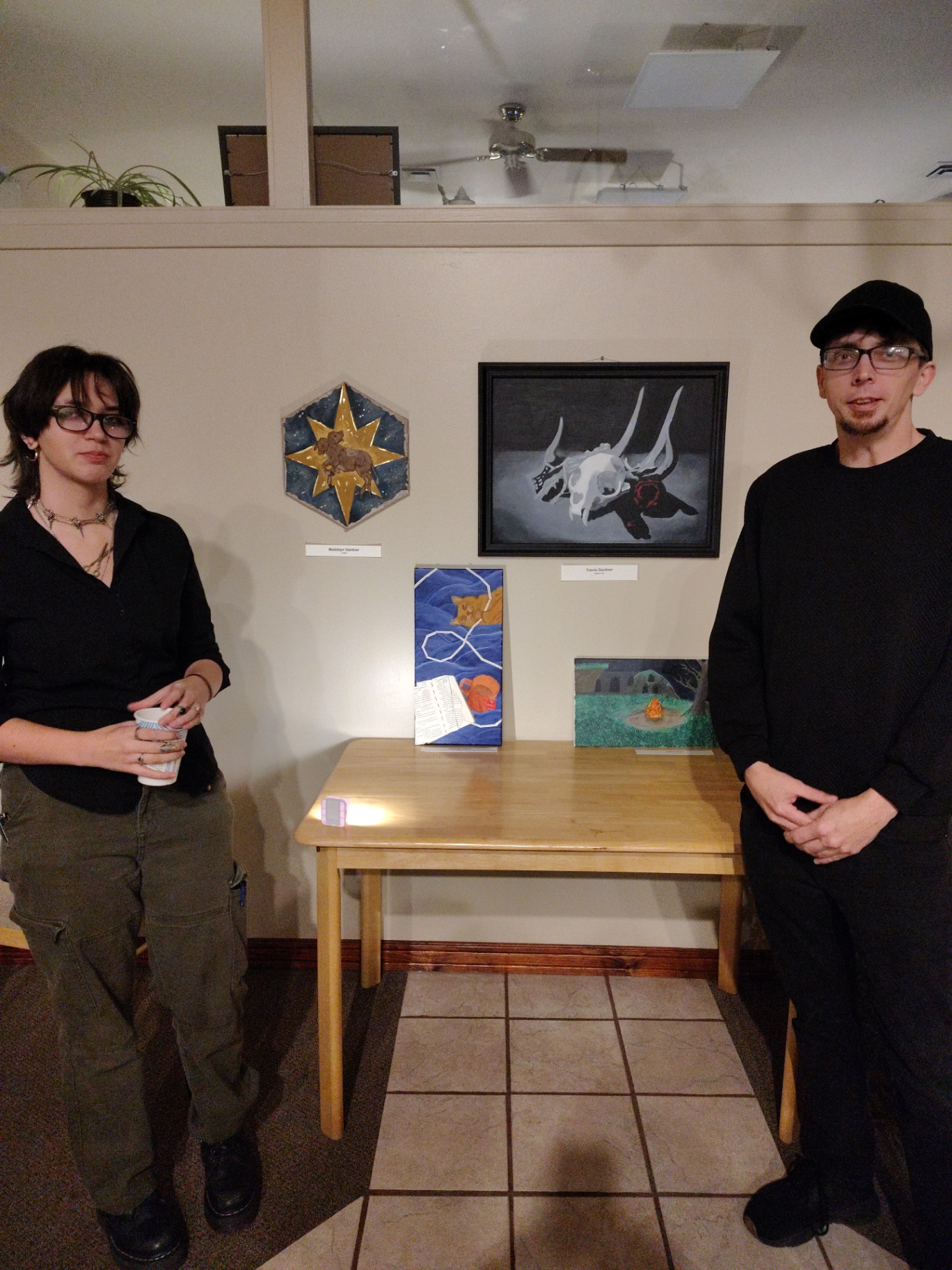The artist with family at a gallery show featuring the goat skull painting
