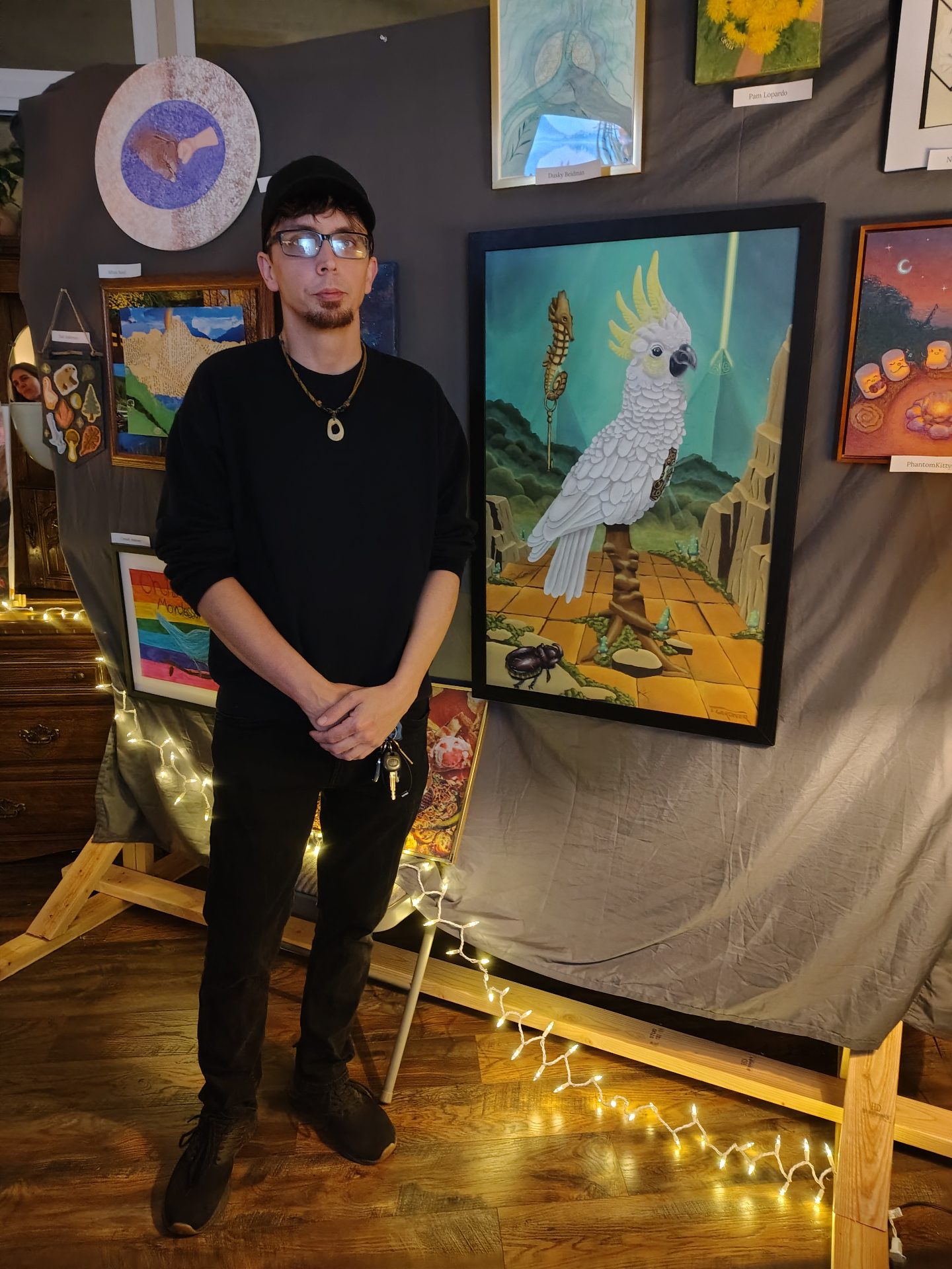 The artist standing next to The Cockatoo Keeper at a gallery show